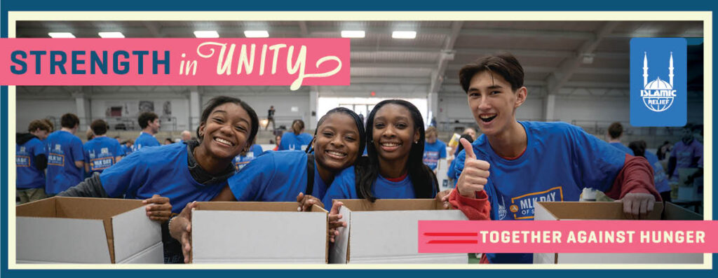 Four volunteers packing food boxes.